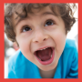 Toddler boy in blue shirt that is really excited.